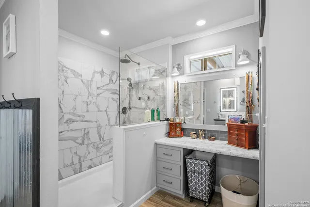 a spacious bathroom with double vanity and a shower