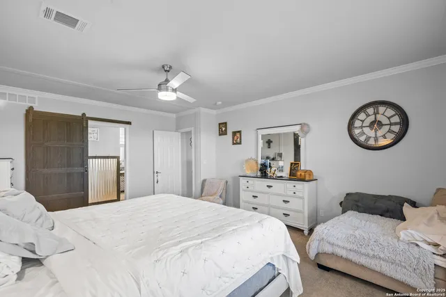 a bedroom with two bed and a chandelier