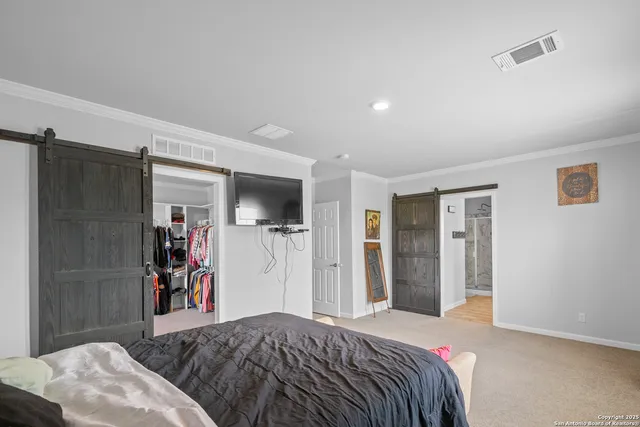 a bedroom with a bed and a mirror