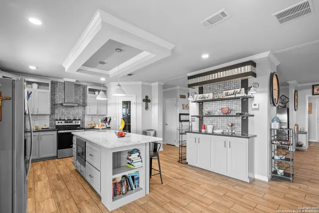 a kitchen with stainless steel appliances granite countertop a stove oven and a refrigerator