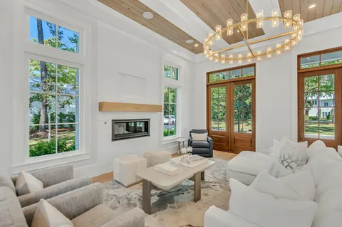 a living room with furniture a window and a table