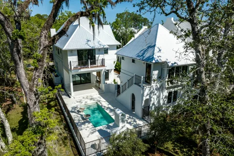 a view of a patio with a dining table and chairs with wooden fence