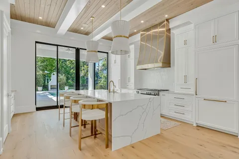 a white bath tub sitting in a bathroom next to a window