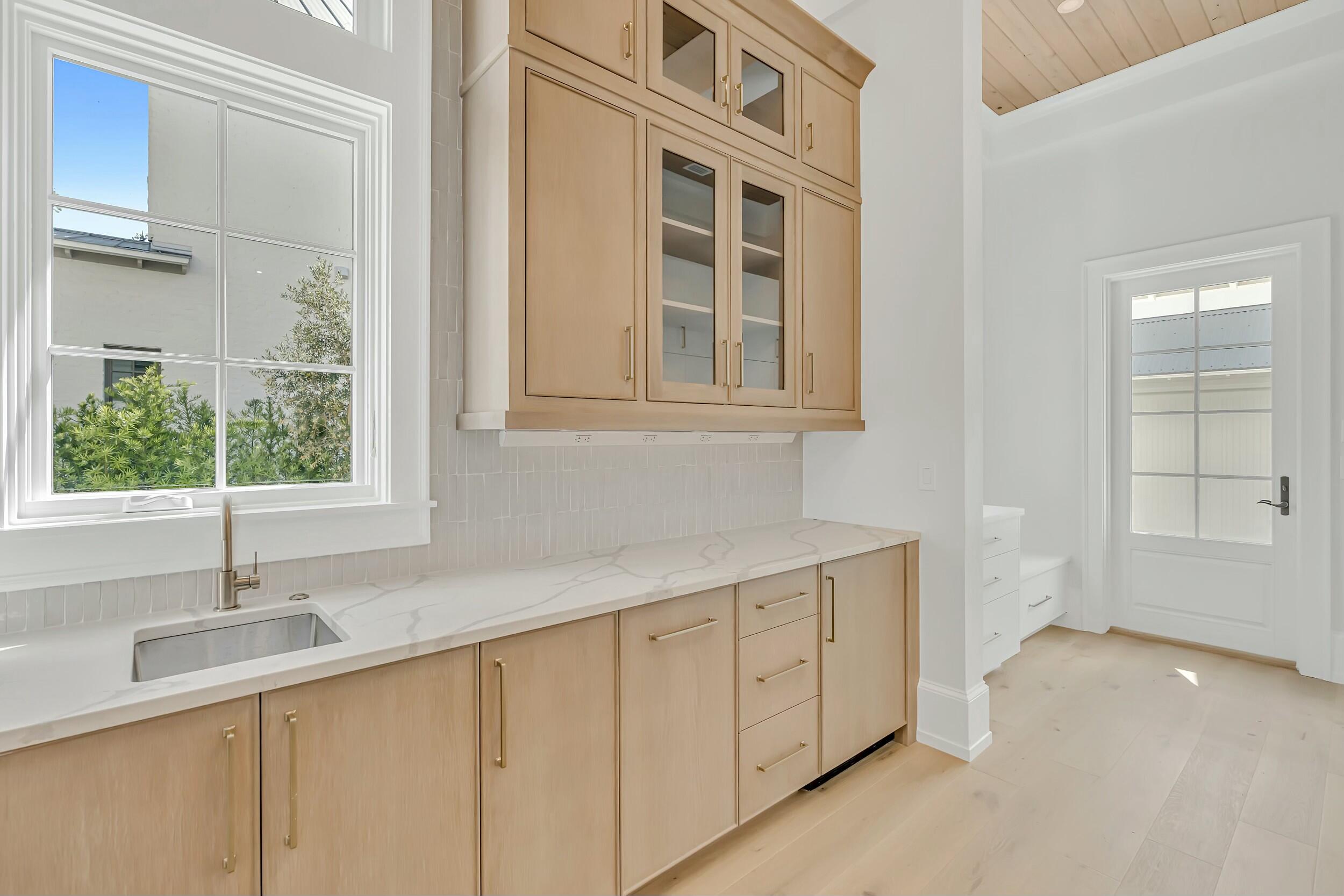 13 Tyler Drive Santa Rosa Beach, FL 32459 - Photo 28 of 78 a kitchen with a sink and cabinets