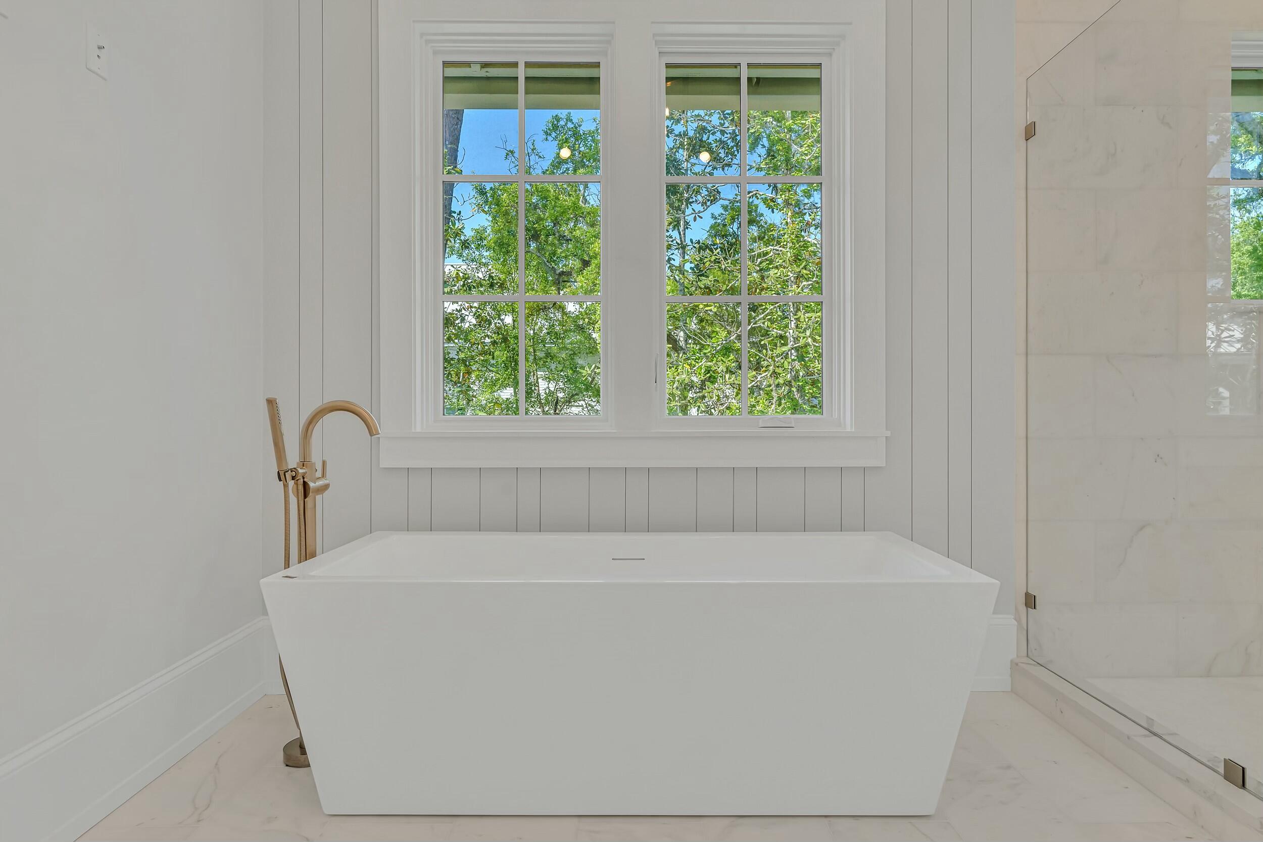 13 Tyler Drive Santa Rosa Beach, FL 32459 - Photo 38 of 78 a white bath tub sitting in a bathroom next to a window