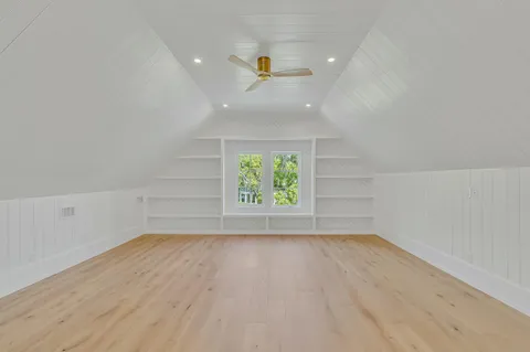 an aerial view of a house with a yard and trees