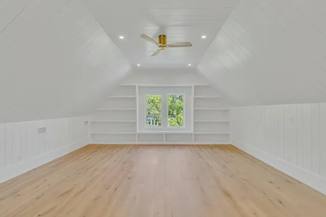 an aerial view of a house with a yard and trees