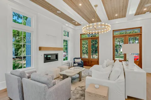 a kitchen with stainless steel appliances granite countertop a stove a refrigerator a sink and white cabinets with wooden floor