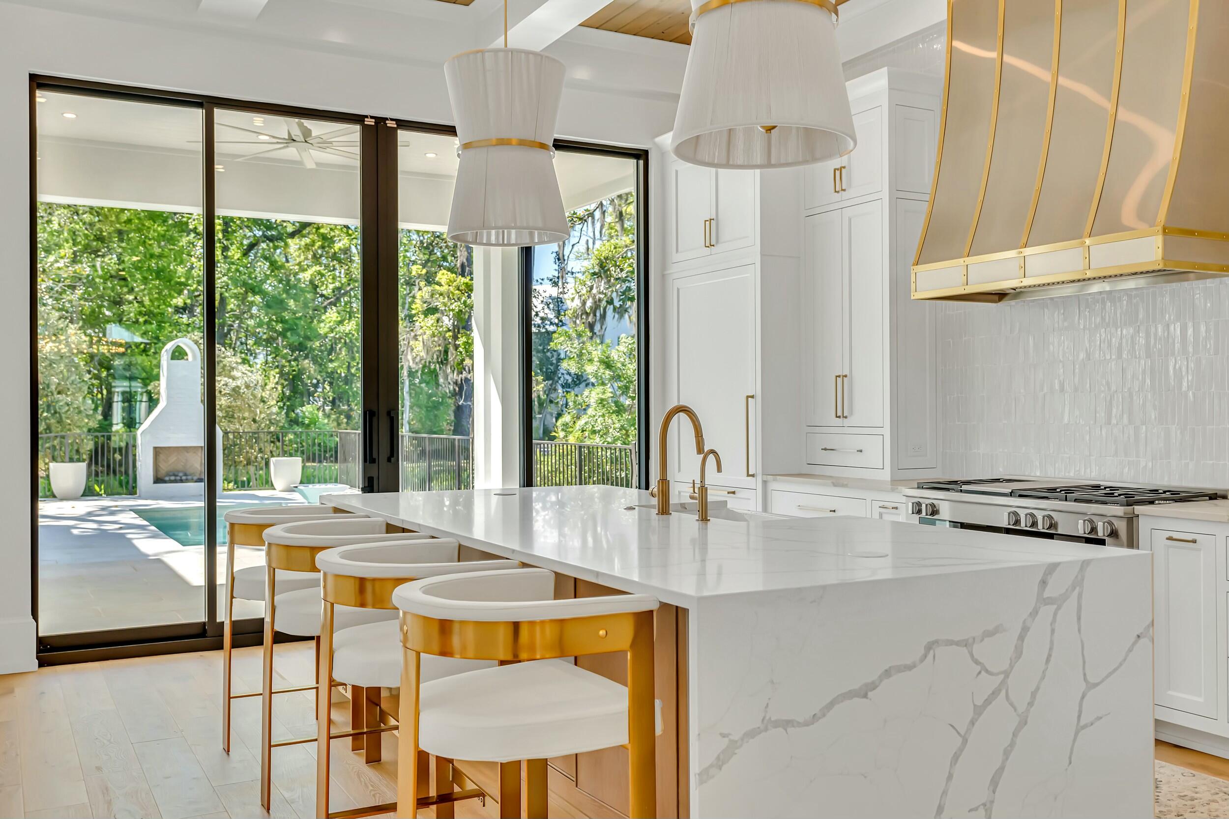 13 Tyler Drive Santa Rosa Beach, FL 32459 - Photo 6 of 78 a kitchen with stainless steel appliances granite countertop a stove a refrigerator a sink and white cabinets with wooden floor