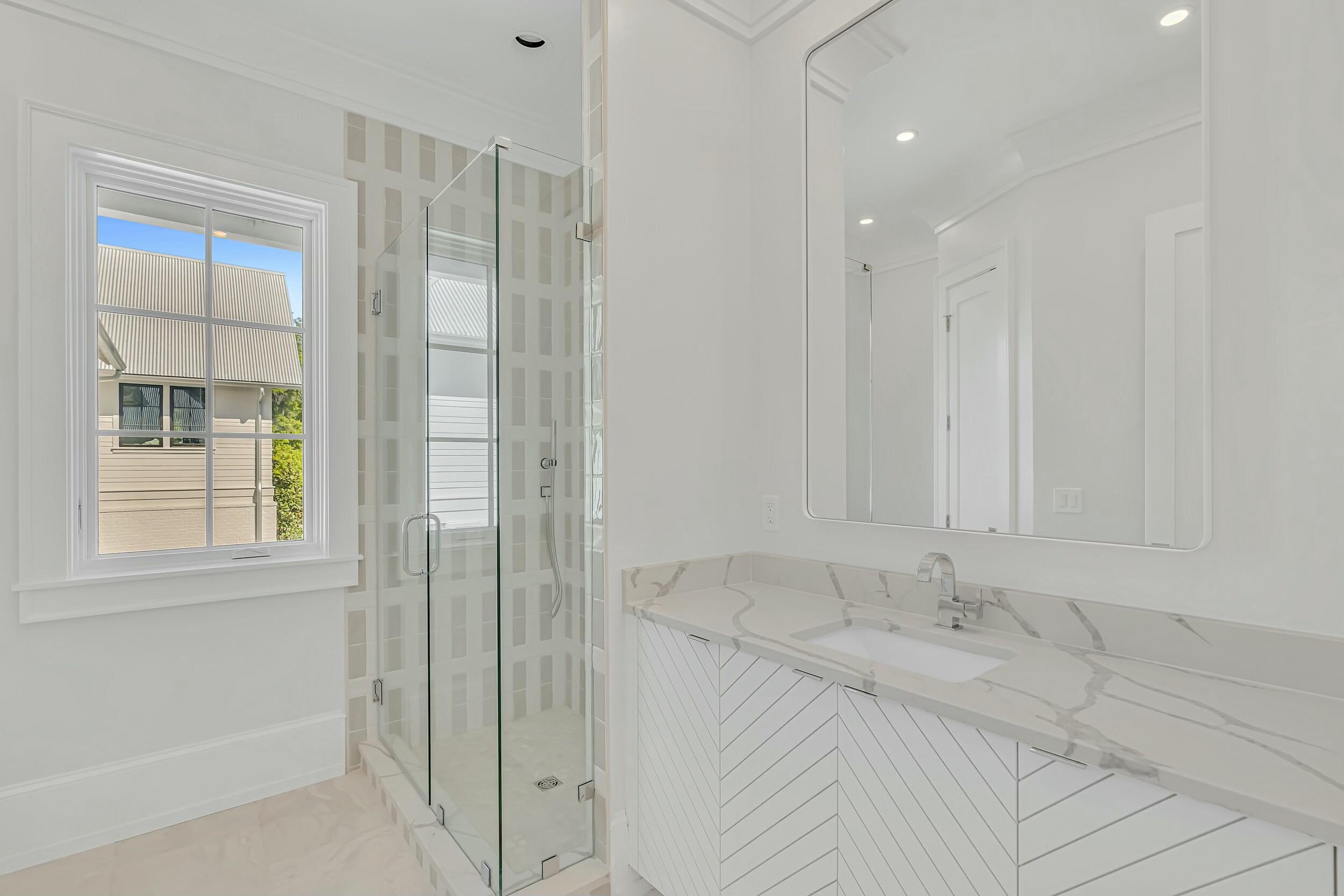 13 Tyler Drive Santa Rosa Beach, FL 32459 - Photo 61 of 78 a bathroom with a granite countertop sink a shower and a mirror