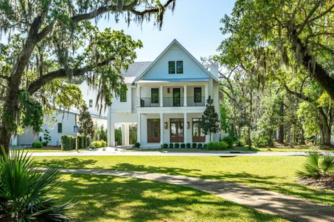 a view of a room with floor to ceiling windows and wooden floor