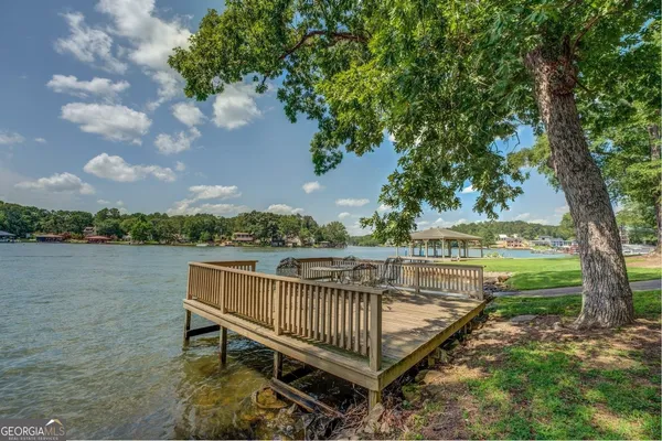 a view of a lake with wooden floor and lake view