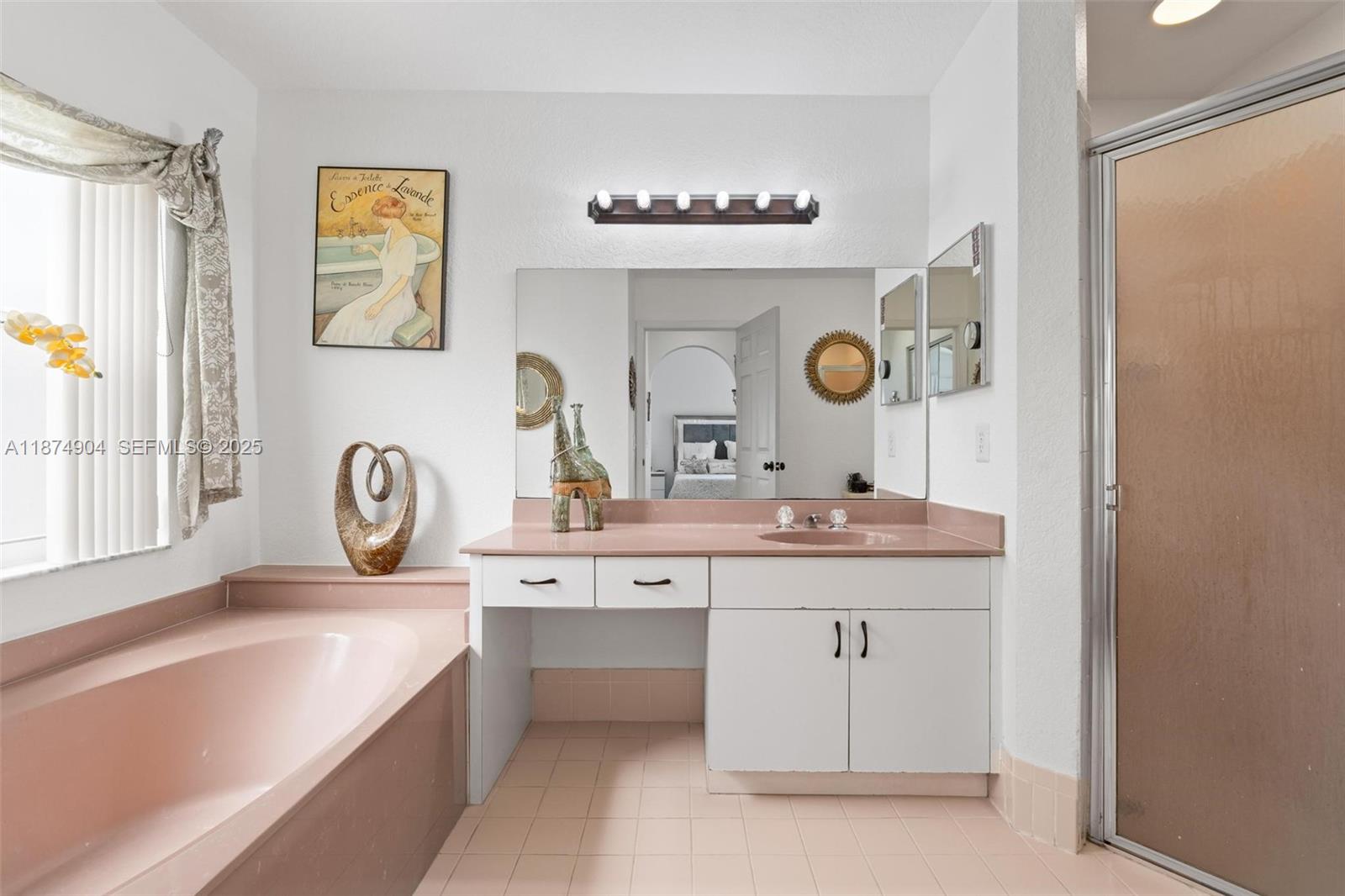 16034 Southwest 83rd Terrace Miami, FL 33193 - Photo 14 of 30 a spacious bathroom with a mirror a sink and a bathtub