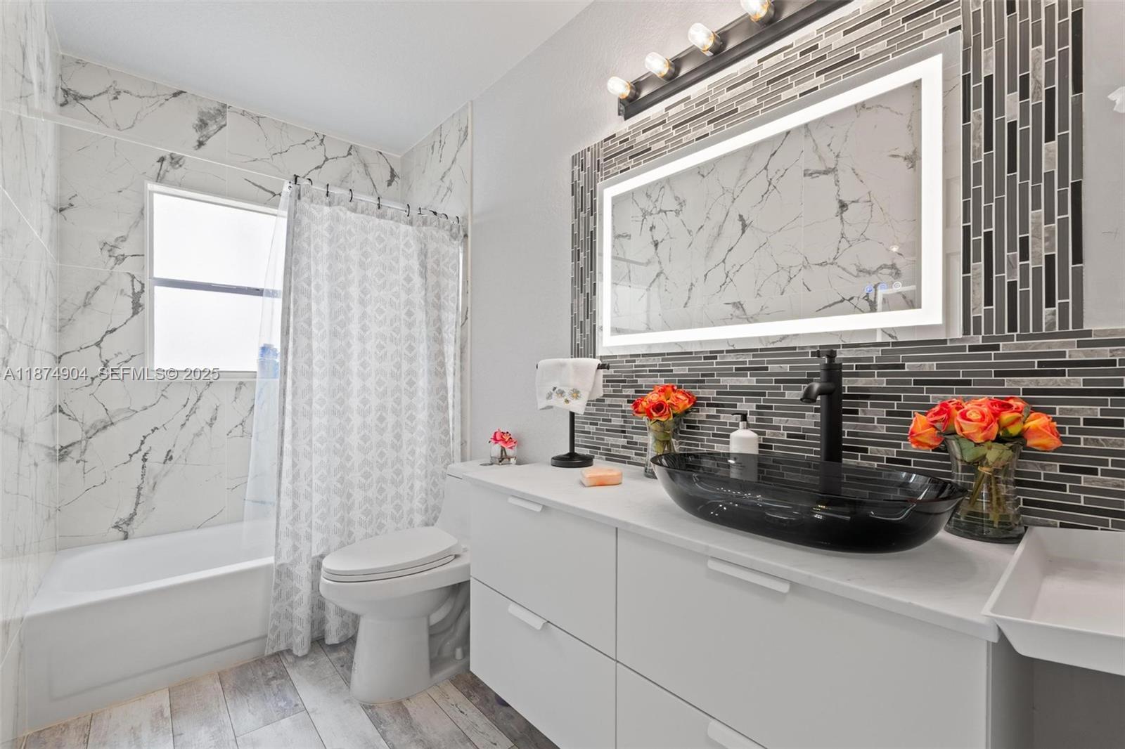 16034 Southwest 83rd Terrace Miami, FL 33193 - Photo 18 of 30 a bathroom with a sink mirror toilet and bathtub