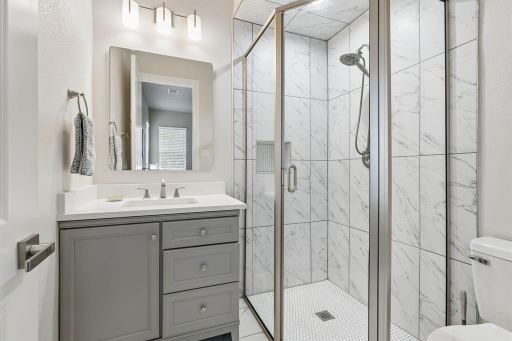 6700 Herbert Road Colleyville, TX 76034 - Photo 18 of 32 a bathroom with a shower and a sink a mirror