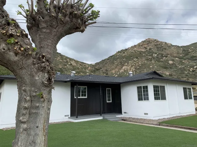 a view of house with yard