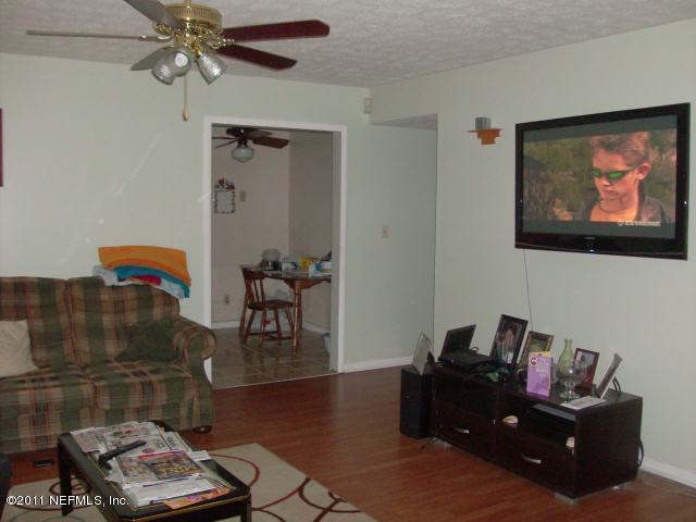 7344 Melvin Road Jacksonville, FL 32210 - Photo 1 of 11 a living room with furniture and a flat screen tv