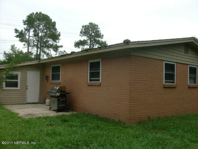 7344 Melvin Road Jacksonville, FL 32210 - Photo 11 of 11 a backyard of a house with table and chairs