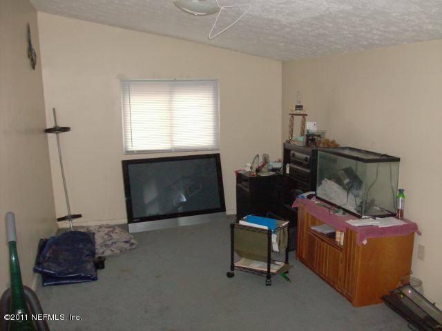 7344 Melvin Road Jacksonville, FL 32210 - Photo 2 of 11 a living room with furniture and a fireplace