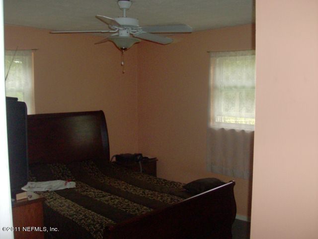 7344 Melvin Road Jacksonville, FL 32210 - Photo 6 of 11 a living room with hardwood floor and a ceiling fan