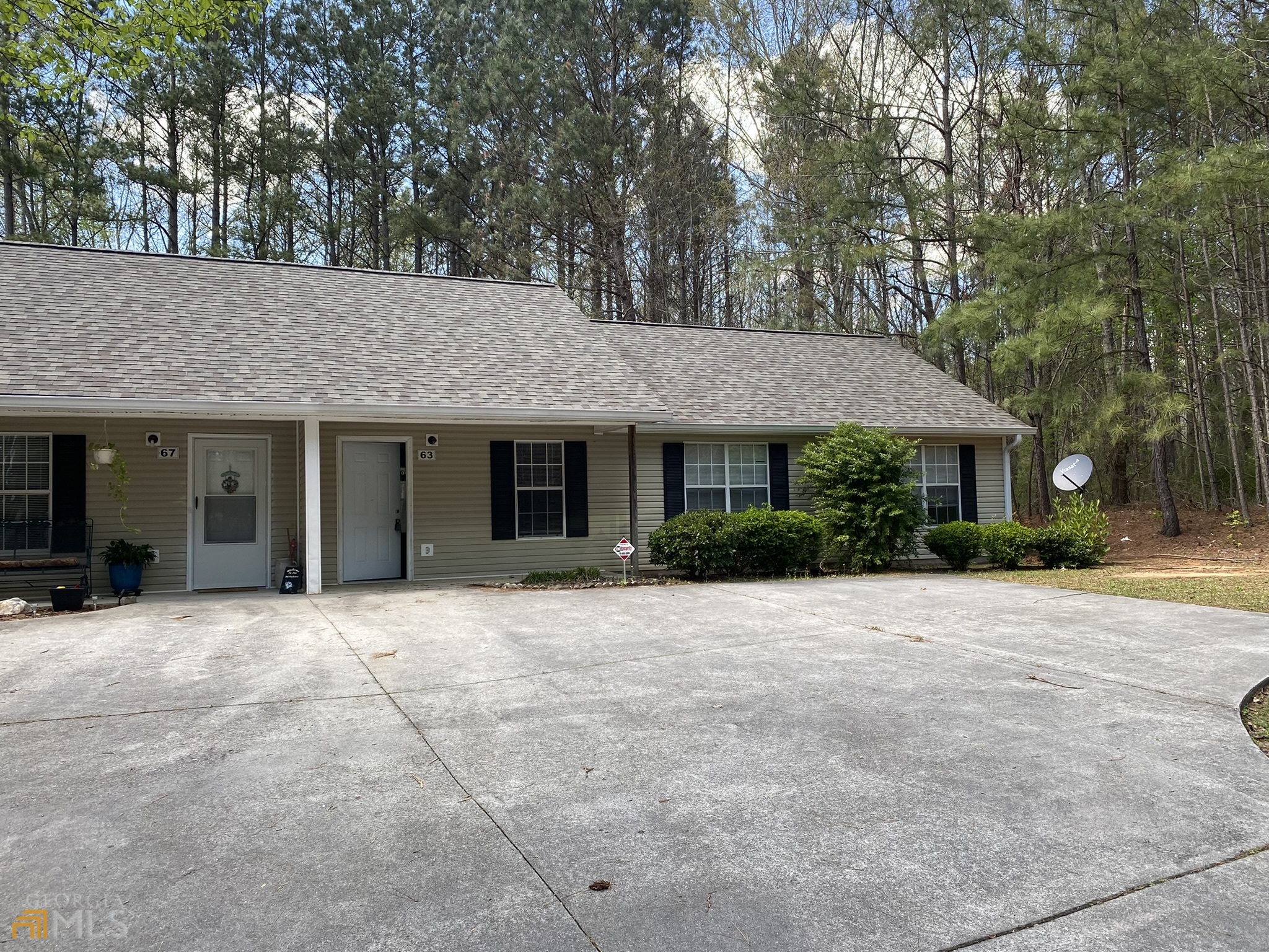 63 West Mandeville Road Carrollton, GA 30117 - Photo 2 of 6 a front view of a house with yard and trees