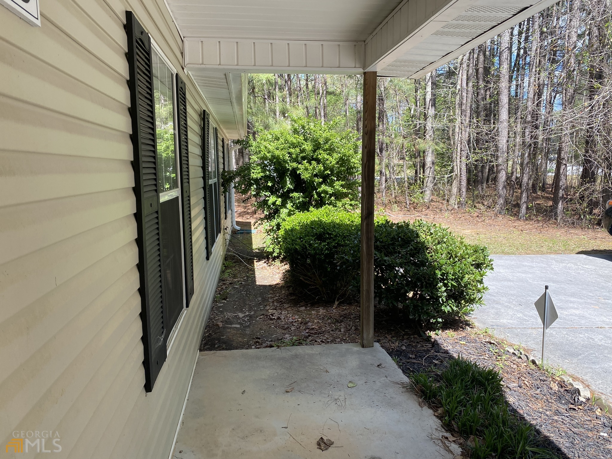 63 West Mandeville Road Carrollton, GA 30117 - Photo 3 of 6 a view of a garden from a porch
