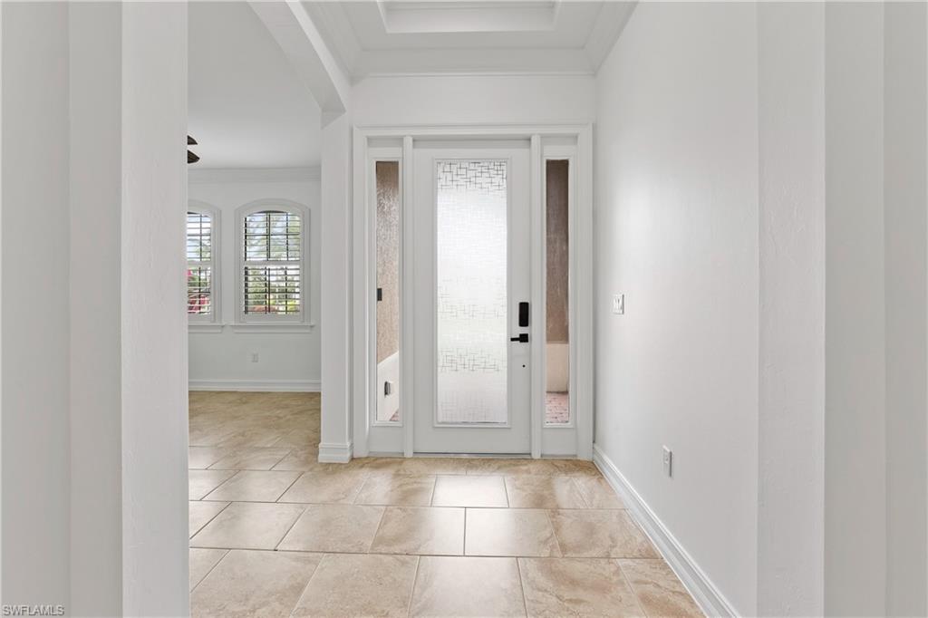 1584 Mockingbird Drive Naples, FL 34120 - Photo 11 of 40 a view of a hallway with wooden floor and a bathroom