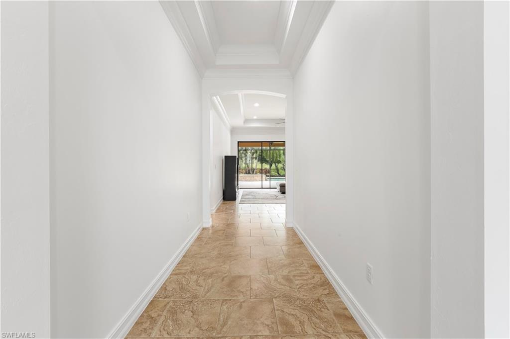 1584 Mockingbird Drive Naples, FL 34120 - Photo 13 of 40 a view of a hallway with wooden floor
