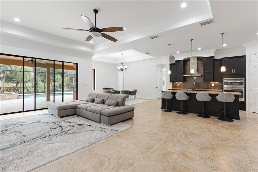 1584 Mockingbird Drive Naples, FL 34120 - Photo 14 of 40 a living room with furniture and a large window