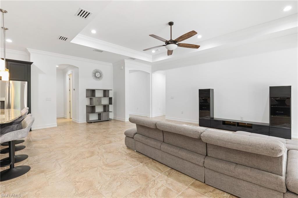 1584 Mockingbird Drive Naples, FL 34120 - Photo 16 of 40 a living room with furniture and a flat screen tv