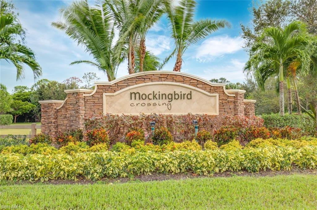 1584 Mockingbird Drive Naples, FL 34120 - Photo 2 of 40 a sign on the side of the road