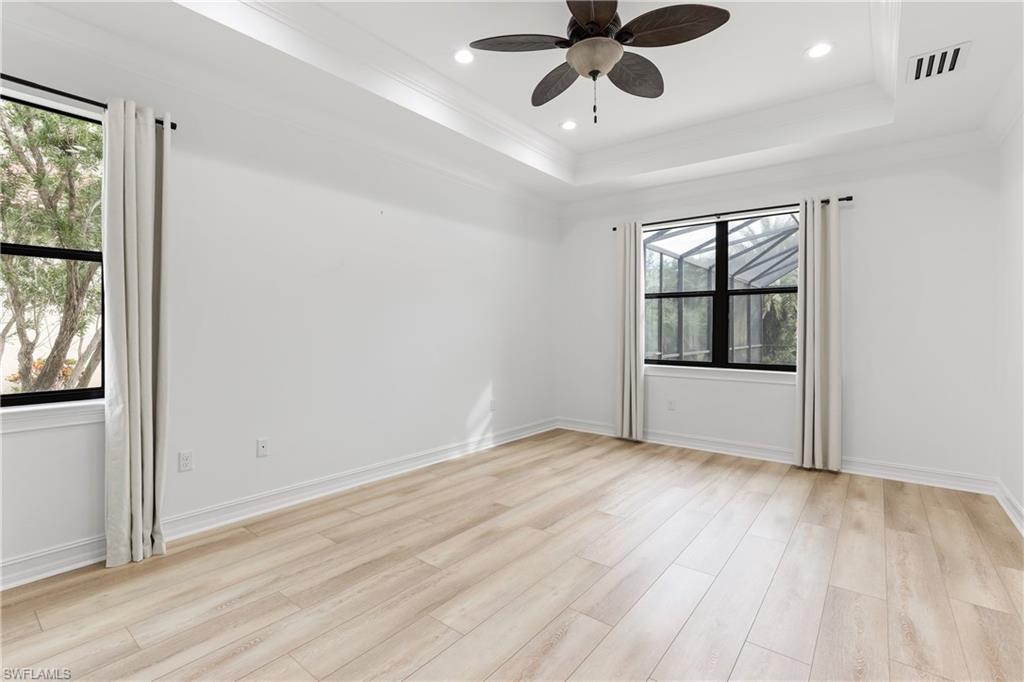 1584 Mockingbird Drive Naples, FL 34120 - Photo 21 of 40 wooden floor in an empty room with a window