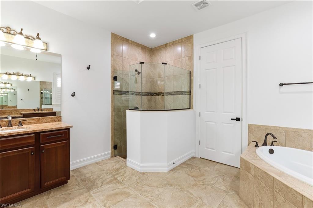 1584 Mockingbird Drive Naples, FL 34120 - Photo 23 of 40 a bathroom with a tub sink and mirror