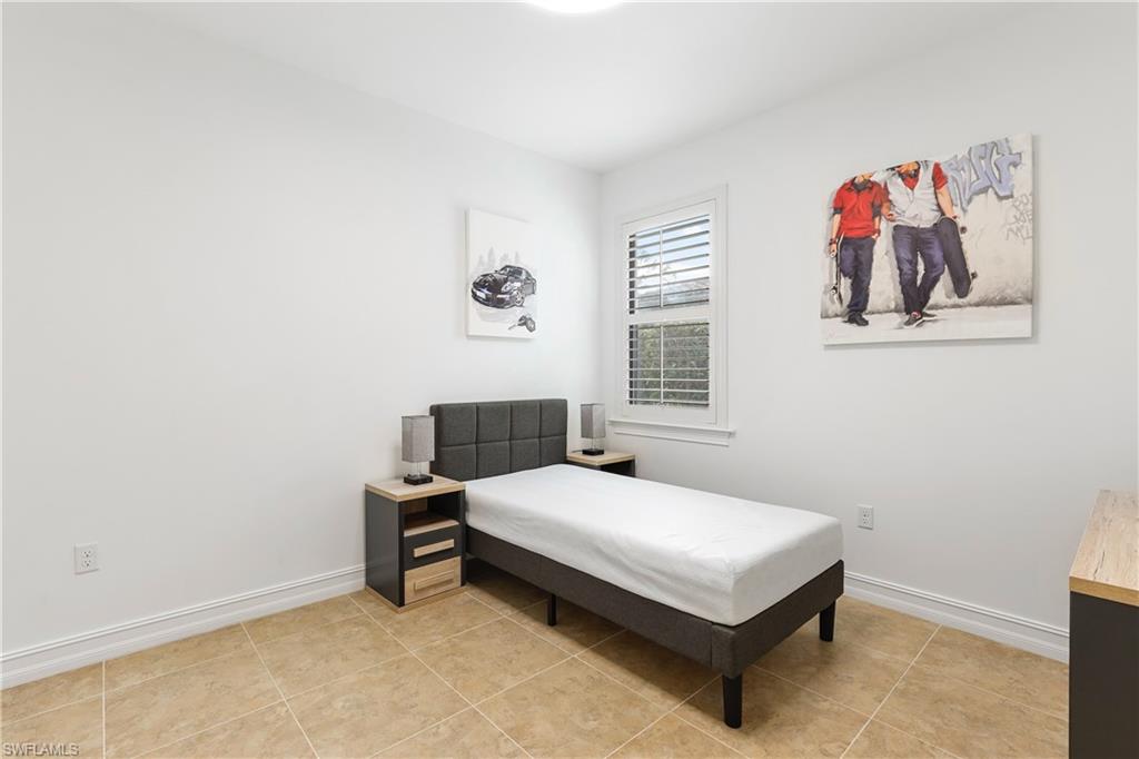 1584 Mockingbird Drive Naples, FL 34120 - Photo 26 of 40 a bedroom with a bed and a window