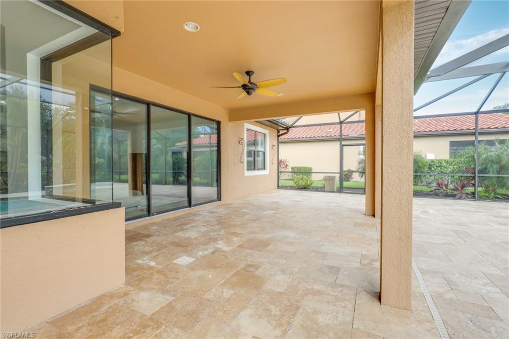 1584 Mockingbird Drive Naples, FL 34120 - Photo 38 of 40 a view of a room with a large window and chandelier
