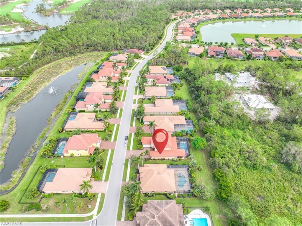 1584 Mockingbird Drive Naples, FL 34120 - Photo 8 of 40 a sign that is sitting in front of flowers