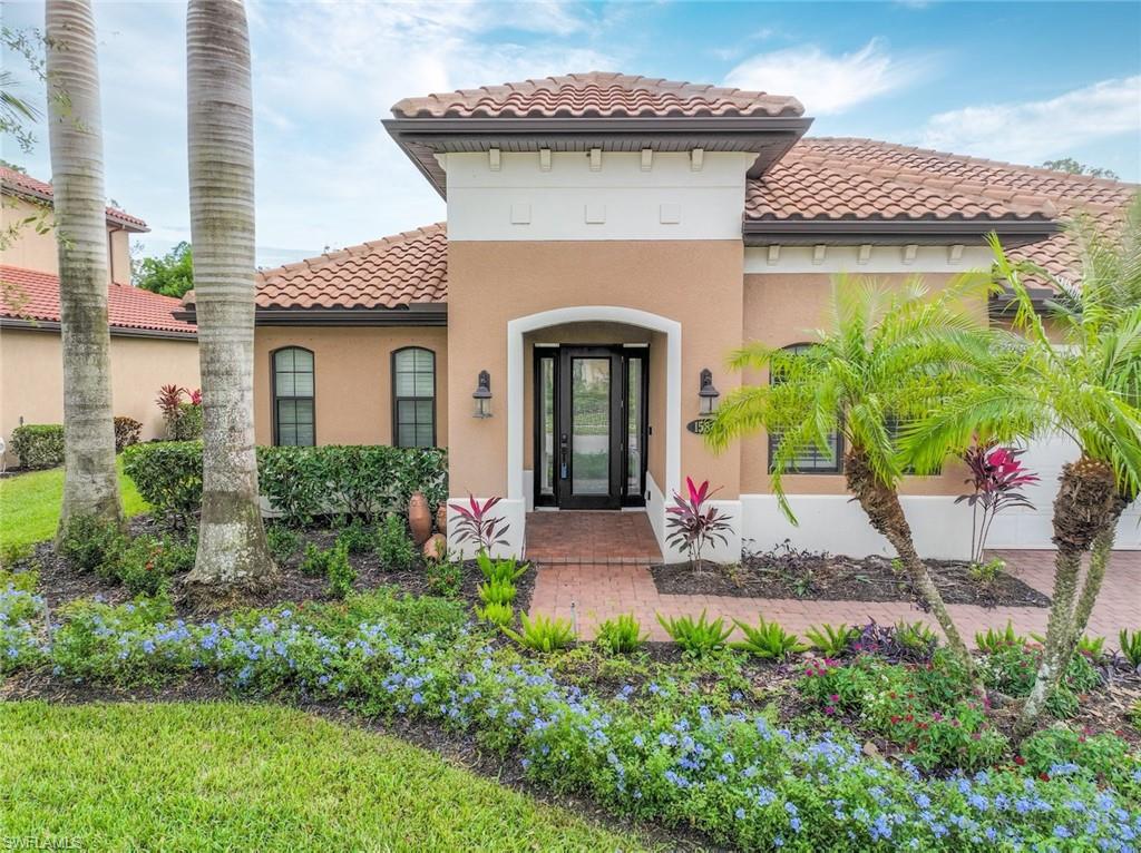 1584 Mockingbird Drive Naples, FL 34120 - Photo 9 of 40 a front view of a house with a garden