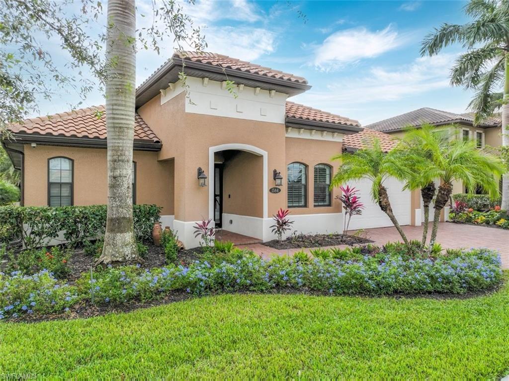 1584 Mockingbird Drive Naples, FL 34120 - Photo 10 of 40 a front view of a house with garden