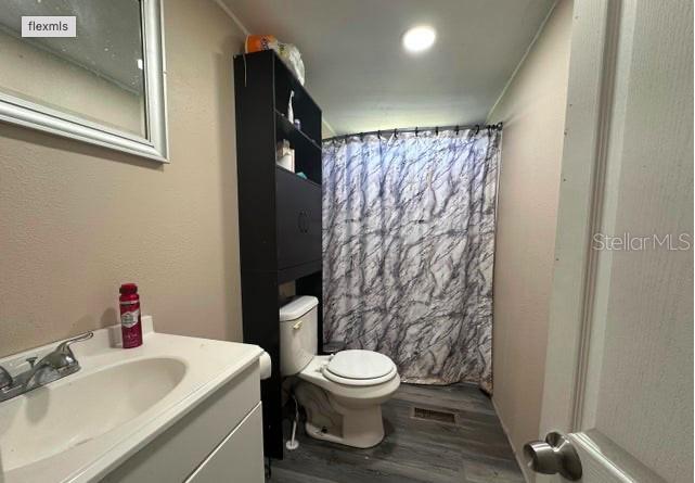 565 Southwest Daisy Road Lake City, FL 32024 - Photo 13 of 15 a white toilet sitting next to a bathroom sink