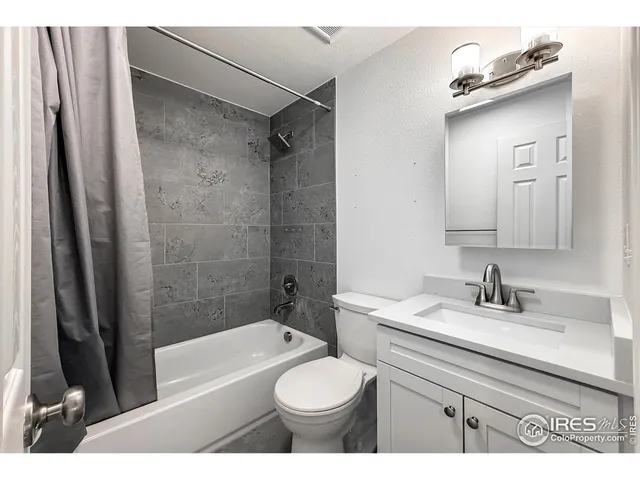a view of a house with a small yard and wooden floor and fence