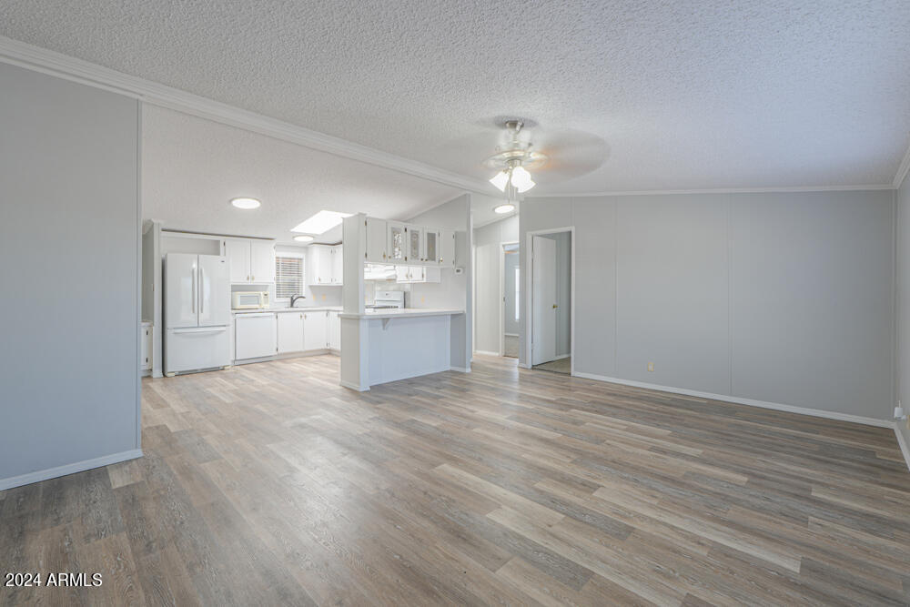 8926 North Thunderbird Road Maricopa, AZ 85139 - Photo 26 of 49 a view of kitchen with wooden floor and refrigerator