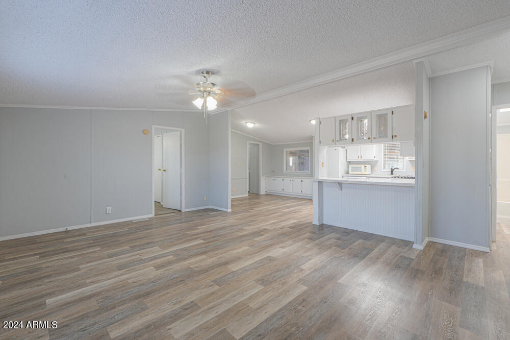 8926 North Thunderbird Road Maricopa, AZ 85139 - Photo 28 of 49 a view of an empty room with a kitchen