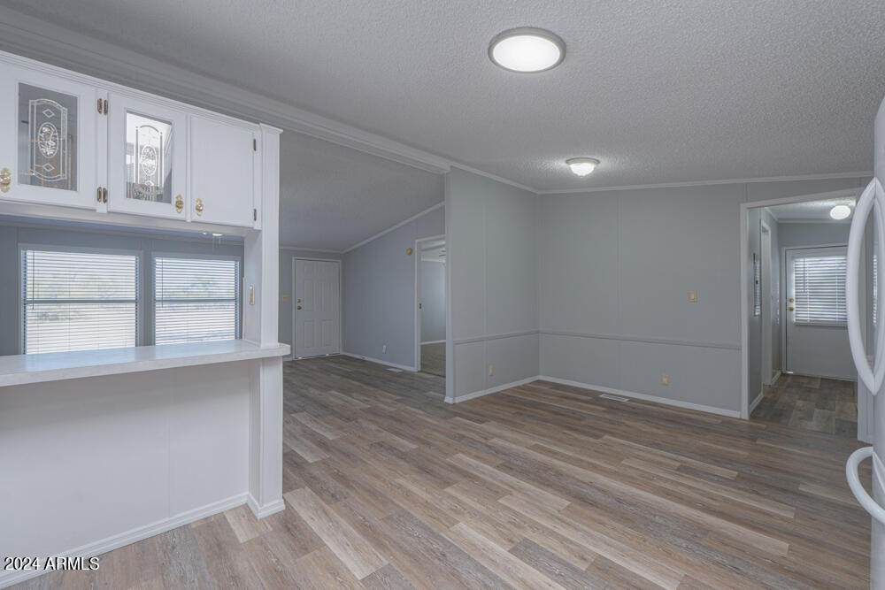 8926 North Thunderbird Road Maricopa, AZ 85139 - Photo 33 of 49 an empty room with wooden floor and windows