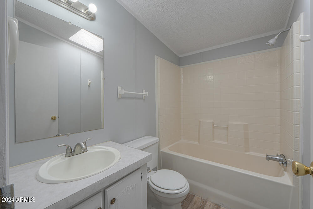 8926 North Thunderbird Road Maricopa, AZ 85139 - Photo 41 of 49 a bathroom with a bathtub shower sink vanity mirror and toilet