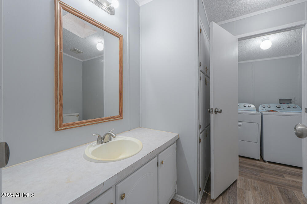 8926 North Thunderbird Road Maricopa, AZ 85139 - Photo 45 of 49 a bathroom with a sink and a mirror