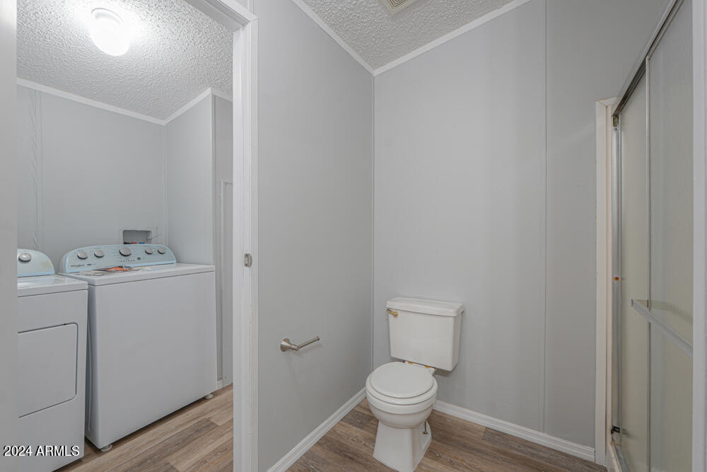 8926 North Thunderbird Road Maricopa, AZ 85139 - Photo 46 of 49 a bathroom with a toilet sink and vanity