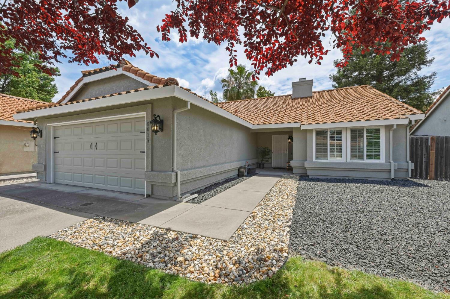 5013 Charter Road Rocklin, CA 95765 - Photo 1 of 35 a front view of a house with a yard and garage