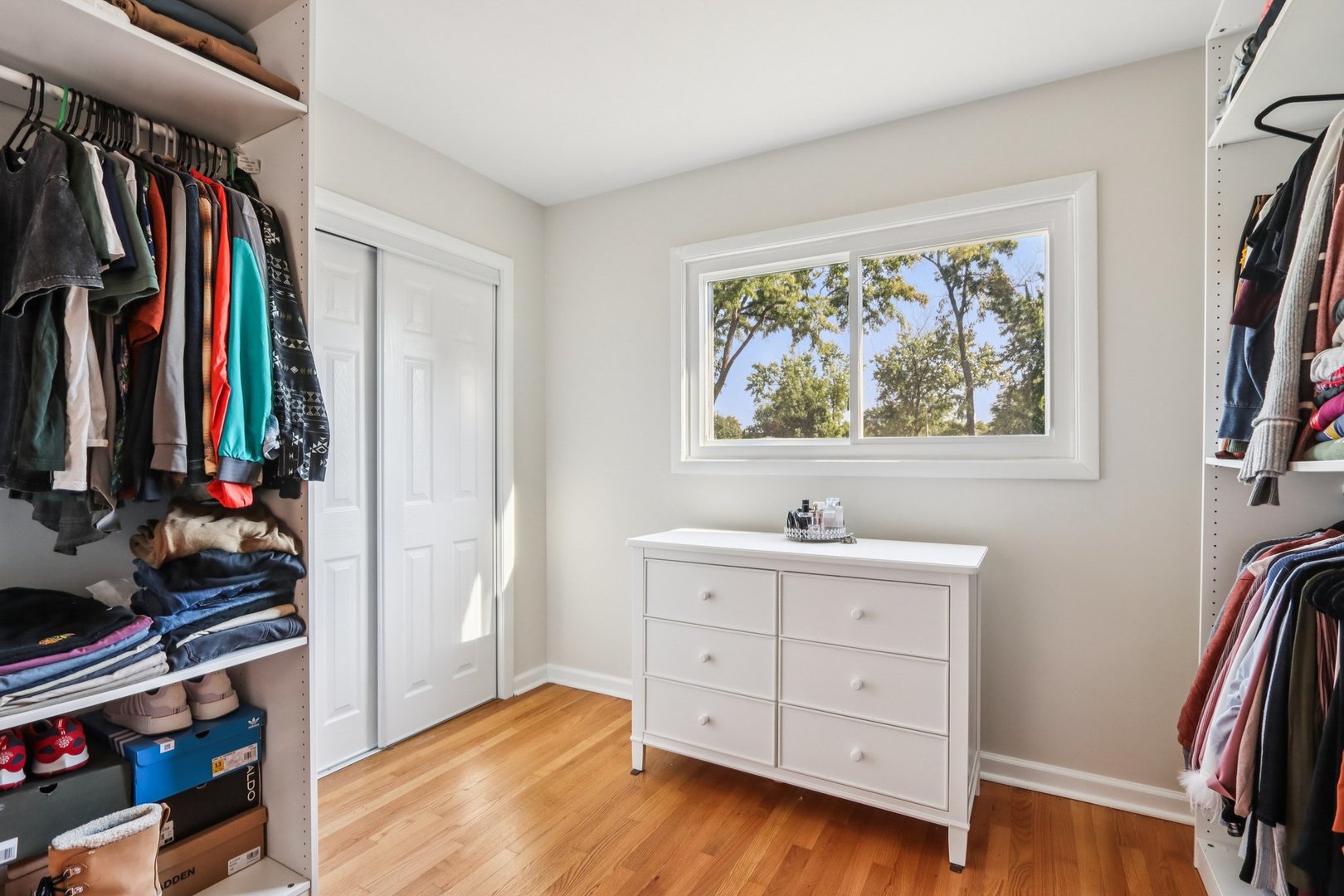 461 Ardmore Terrace Addison, IL 60101 - Photo 17 of 29 a view of walk in closet with clothes and shoes