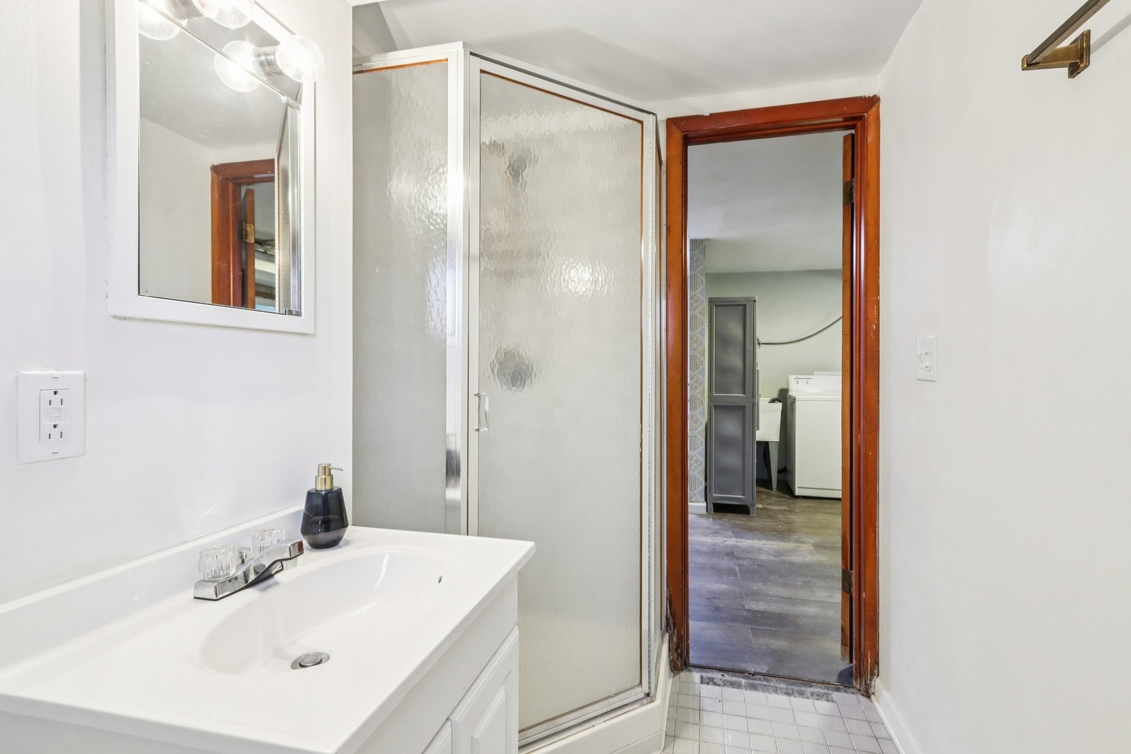 461 Ardmore Terrace Addison, IL 60101 - Photo 22 of 29 a bathroom with a sink a mirror and a shower