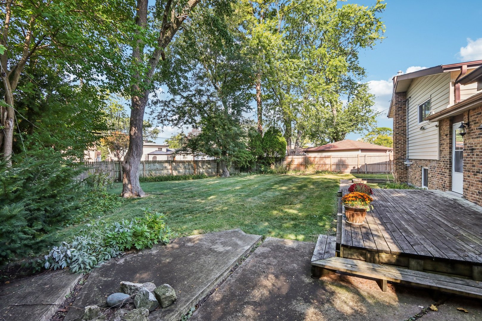 461 Ardmore Terrace Addison, IL 60101 - Photo 25 of 29 a view of a wooden deck and garden